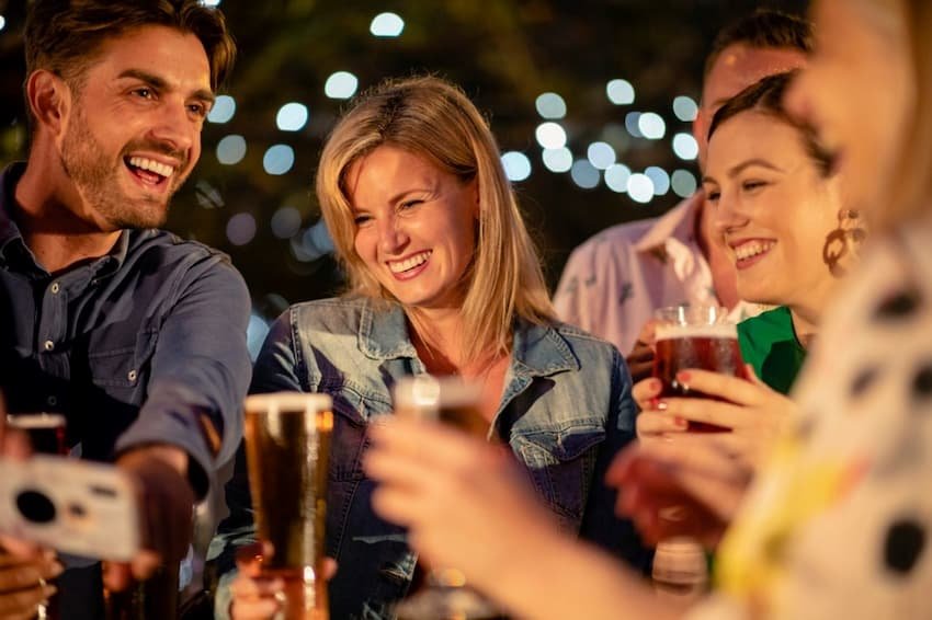 A group of people holding drinks