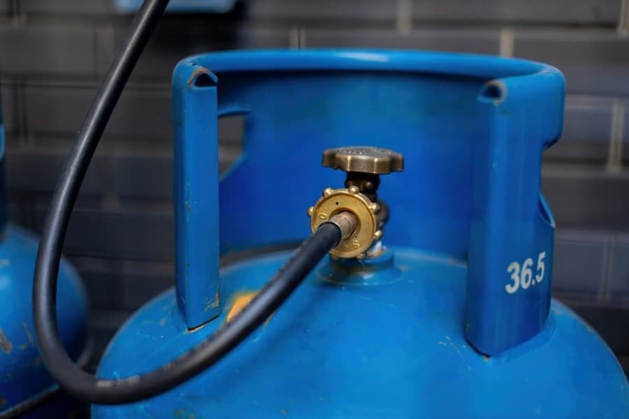 A blue gas cylinder with a valve
