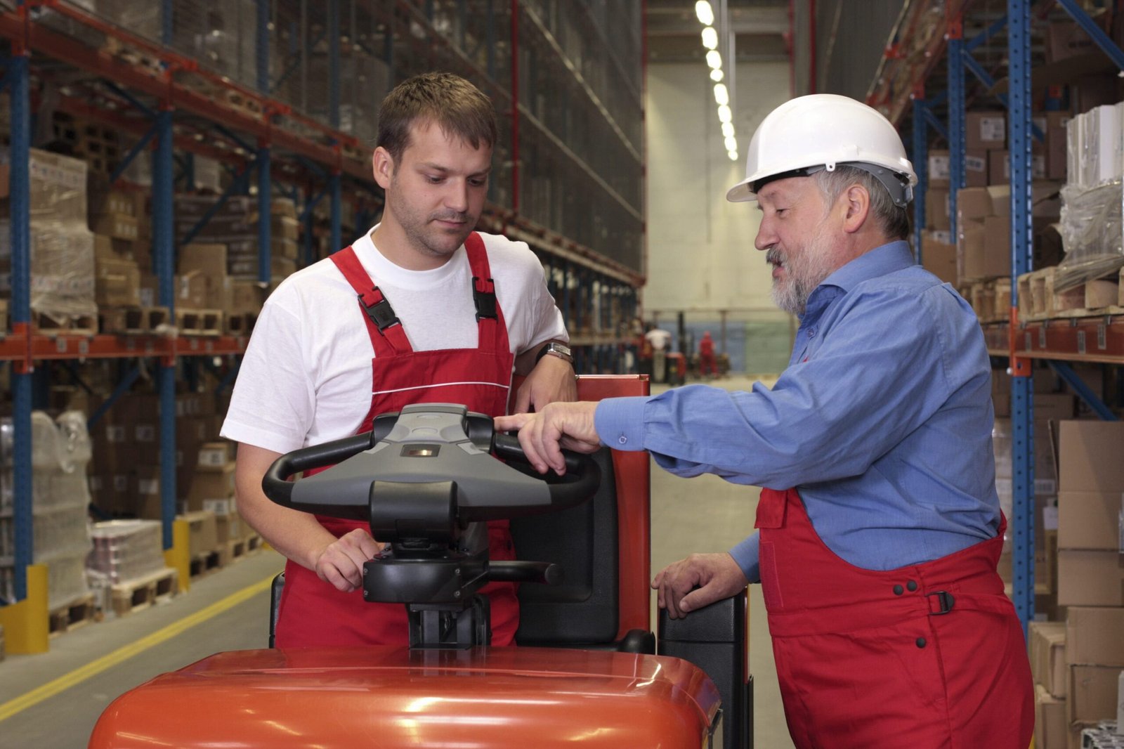Workers with forklift in factory