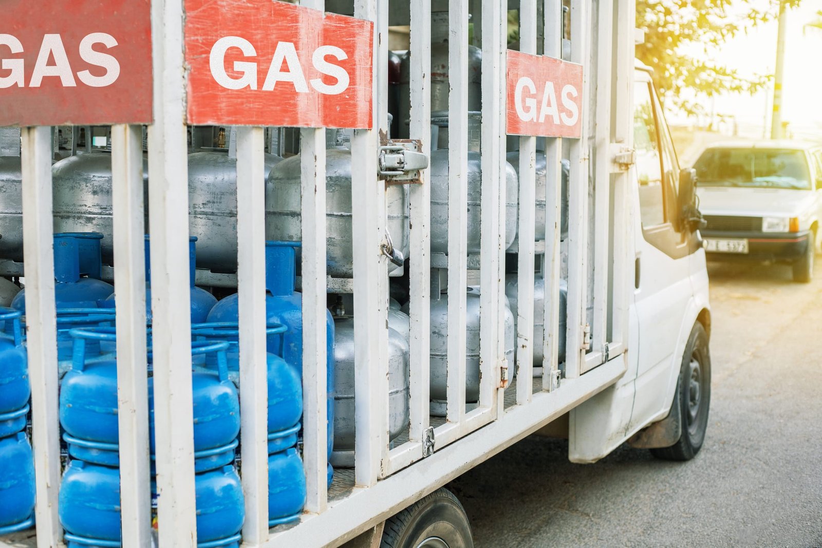Truck with gas cylinders on the city road. Truck delivered propane cylinders.